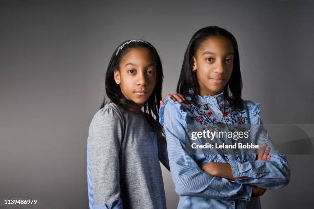 portrait of 11 year old twin sisters - of the same girl stock pictures, royalty-free photos & images