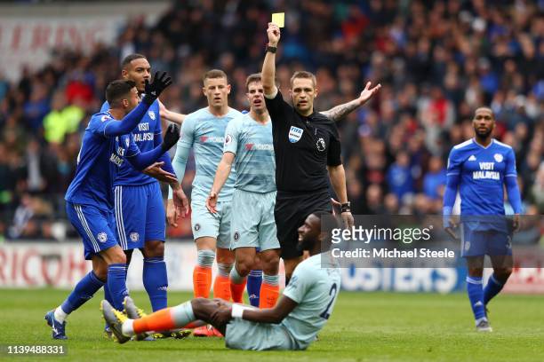 Match Referee Craig Pawson shows Antonio Ruediger of Chelsea the yellow card during the Premier League match between Cardiff City and Chelsea FC at...