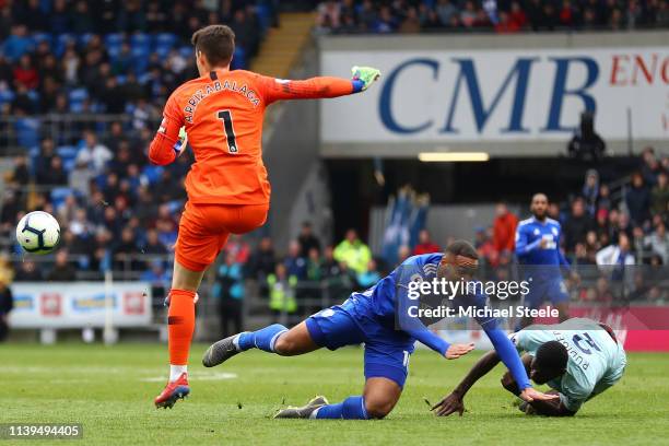 Kenneth Zohore of Cardiff City is challenged by Antonio Ruediger of Chelsea which leads to Antonio Ruediger of Chelsea being shown the yellow card...