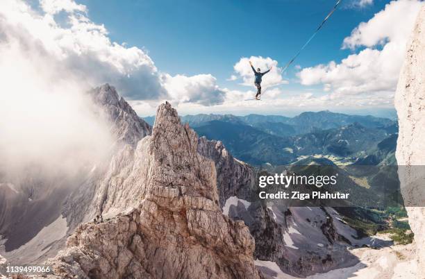 bold move - slack line - rope walking stock pictures, royalty-free photos & images