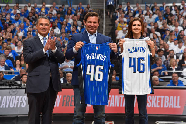 Governor Ron DeSantis receives a jersey before the game between Toronto Raptors and the Orlando Magic during Game Three of Round One of the 2019 NBA...