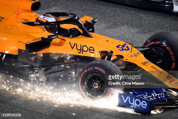 Sparks fly from the front wing of Carlos Sainz of Spain driving the McLaren F1 Team MCL34 Renault on track during the F1 Grand Prix of Bahrain at...
