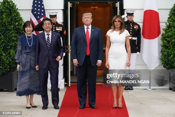 President Donald Trump and First Lady Melania Trump greet Japan's Prime Minister Shinzo Abe and his wife Akie Abe at the South Portico of the White...