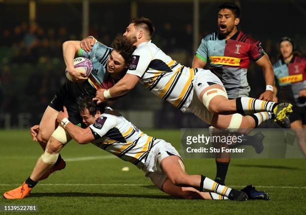 Quins player Cadan Murley is tackled by Francois Venter and Cornell du Preez during the Challenge Cup Quarter Final match between Worcester Warriors...
