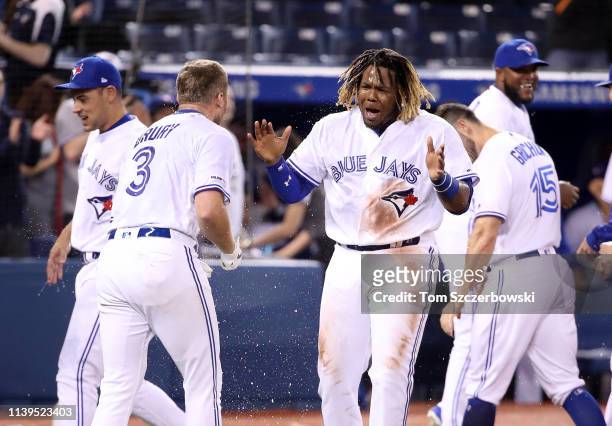 Vladimir Guerrero Jr. #27 of the Toronto Blue Jays celebrates their victory as Brandon Drury hit a game-winning two-run home run in the ninth inning...