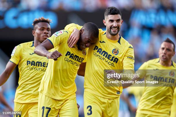 Toko Ekambi of Villarreal CF celebrates with Alvaro Gonzalez and team mates of Villarreal CF after scoring his team's first goal during the La Liga...