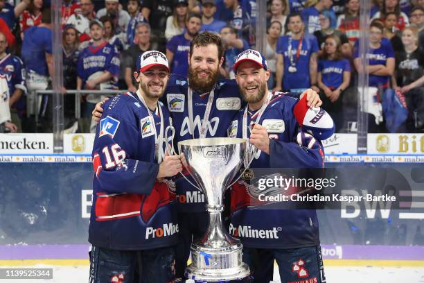 Markus Eisenschmid of Adler Mannheim, Thomas Larkin of Adler Mannheim and Marcus Kink of Adler Mannheim pose with trophy after the fifth game of the...