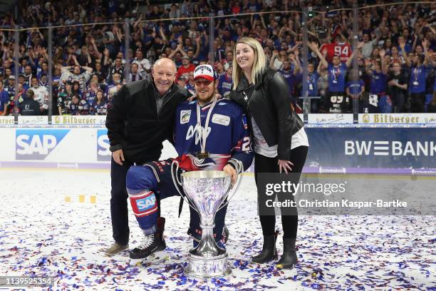 Brendan Mikkelson of Adler Mannheim poses with trophy after the fifth game of the DEL Play-Offs Final between Adler Mannheim and EHC Red Bull...