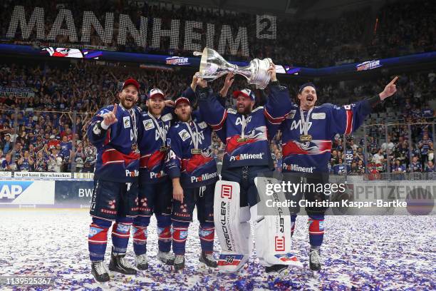 Chad Kolarik of Adler Mannheim, Chet Pickard of Adler Mannheim and Luke Adam of Adler Mannheim pose with trophy after the fifth game of the DEL...