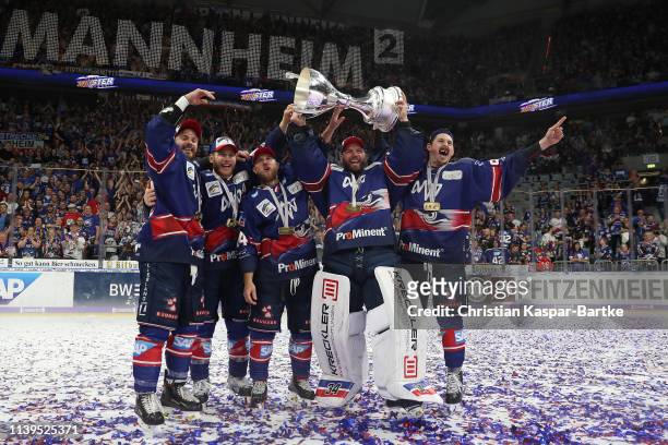 Chad Kolarik of Adler Mannheim, Chet Pickard of Adler Mannheim and Luke Adam of Adler Mannheim pose with trophy after the fifth game of the DEL...