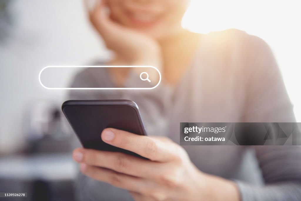 Closeup woman hands using mobile phone with Searching Browsing Internet Data Information Networking Concept.