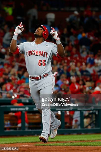 Yasiel Puig of the Cincinnati Reds celebrates after hitting two-run home run against the St. Louis Cardinals in the eighth inning at Busch Stadium on...