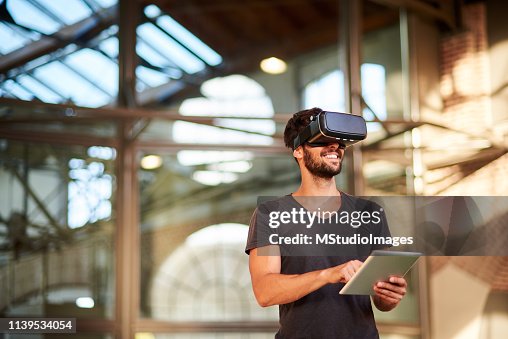 Man using virtual reality simulator headset Man using virtual reality simulator headset