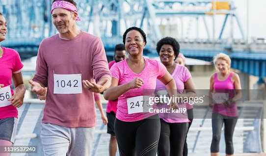 African-American woman with group in breast cancer rally African-American woman with group in breast cancer rally