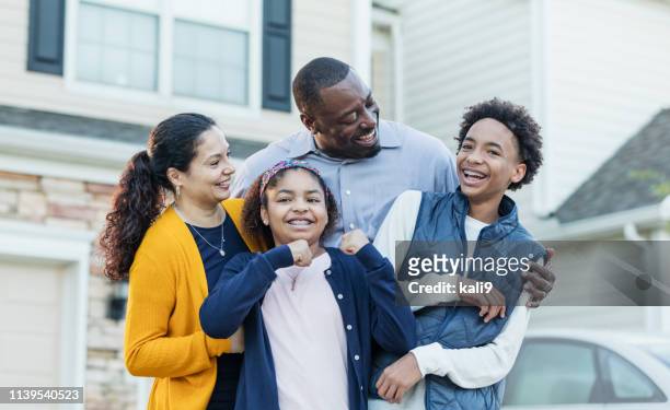 mixed race african-american and hispanic family - suburban family stock pictures, royalty-free photos & images