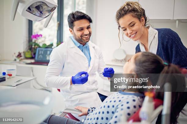 mother and daughter in the dentist office - dental office stock pictures, royalty-free photos & images