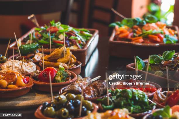 tapas snacks in a tapas bar - spanish culture stock-fotos und bilder