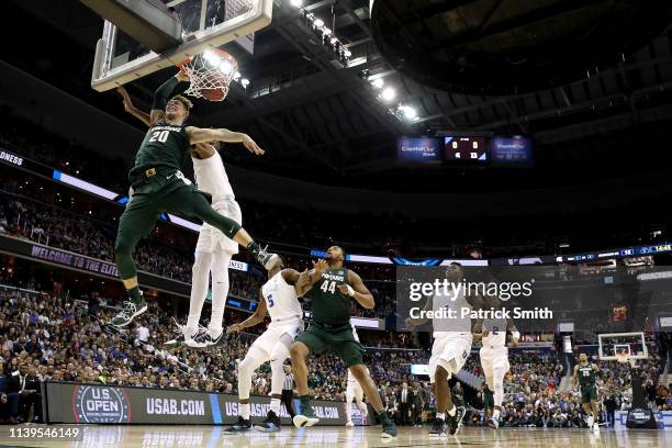 Matt McQuaid of the Michigan State Spartans dunks the ball against the Duke Blue Devils during the first half in the East Regional game of the 2019...