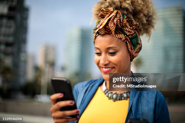 text messaging. - jamaica people stock pictures, royalty-free photos & images