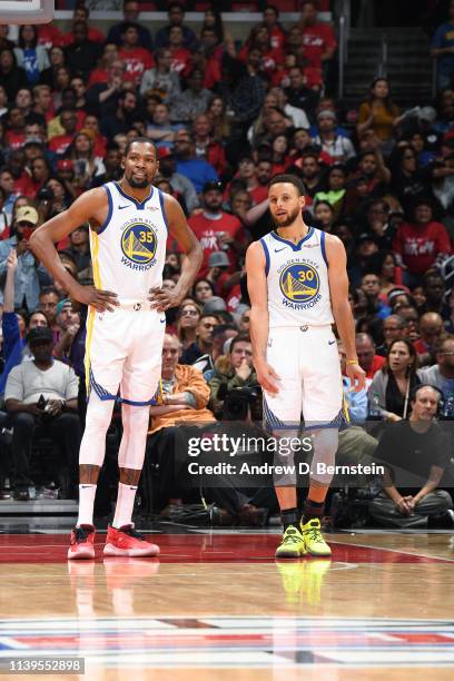 Kevin Durant and Stephen Curry of the Golden State Warriors look on against the LA Clippers during Game Six of Round One of the 2019 NBA Playoffs on...