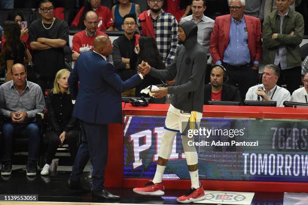 Head Coach Doc Rivers of the LA Clippers exchange hi-fives with Kevin Durant of the Golden State Warriors after Game Six of Round One of the 2019 NBA...