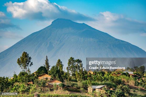 village and volcano - ominous mountains stock pictures, royalty-free photos & images