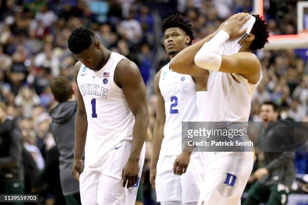 Zion Williamson, Cam Reddish and Tre Jones of the Duke Blue Devils react after their teams 68-67 loss to the Michigan State Spartans in the East...