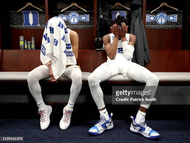 Tre Jones and Cam Reddish of the Duke Blue Devils react in the locker room after their teams 68-67 loss to the Michigan State Spartans in the East...