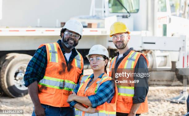 woman in charge at construction site - protective workwear construction stock pictures, royalty-free photos & images