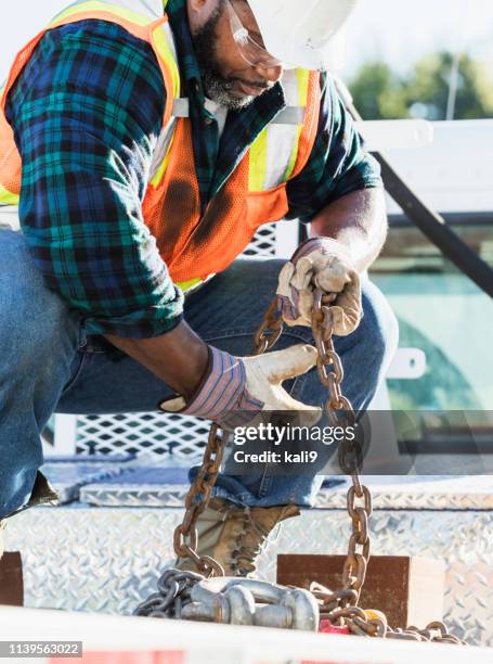 african-american construction worker on a crane - builders boots stock pictures, royalty-free photos & images