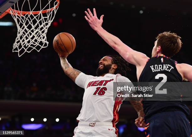 James Johnson of the Miami Heat attempts a dunk against Luke Kornet of the New York Knicks during the first half of the game at Madison Square Garden...