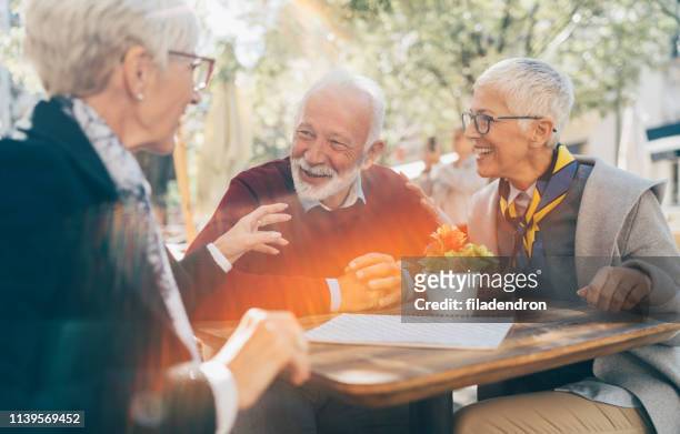 senior friends have fun - senior women cafe stock pictures, royalty-free photos & images