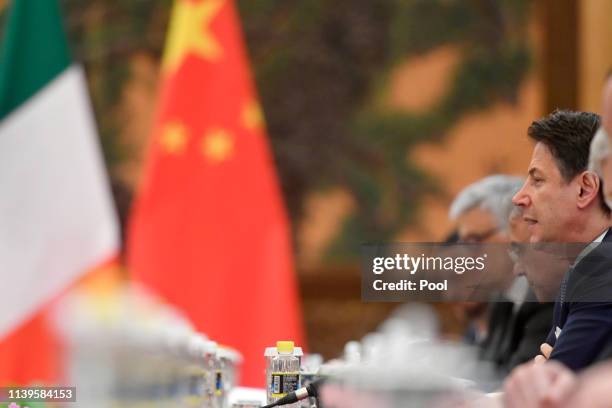 Italian Prime Minister Giuseppe Conte speaks with Chinese President Xi Jinping during their meeting at the Great Hall of the People in Beijing,...