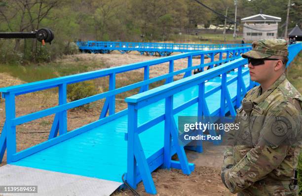 Soldier stands next to the blue bridge ahead of a ceremony to mark the first anniversary of Panmunjom declaration between South Korean President Moon...