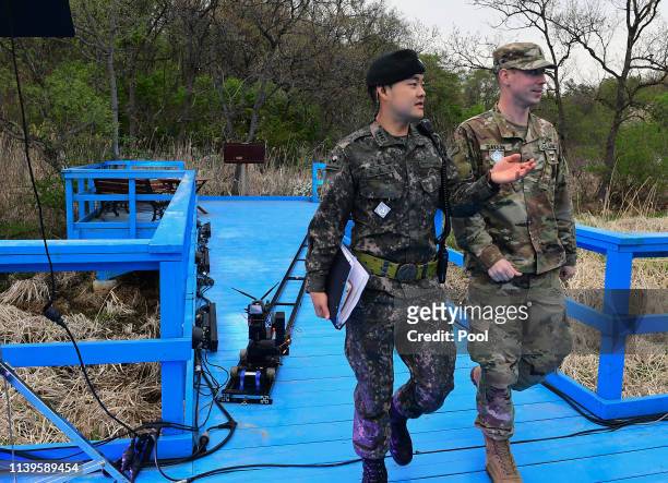 South Korean soldier talks with US soldier on the blue bridge ahead of a ceremony to mark the first anniversary of Panmunjom declaration between...