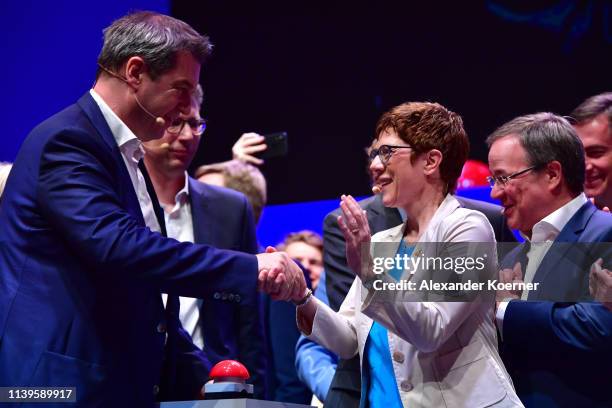 Annagret Kramp-Karrenbauer, head of the German Christian Democrats and Markus Soeder, head of the Bavarian Christian Democrats , cheer during the...