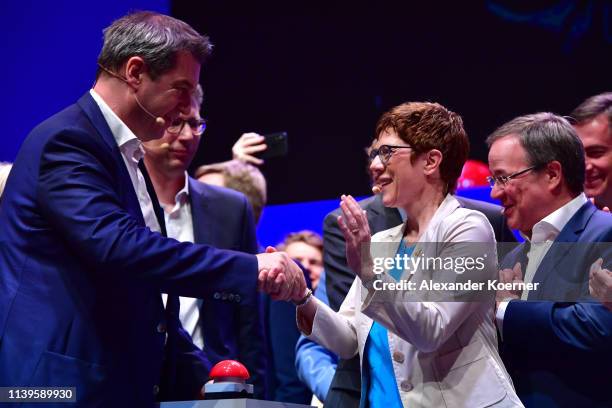 Annagret Kramp-Karrenbauer, head of the German Christian Democrats and Markus Soeder, head of the Bavarian Christian Democrats , cheer during the...