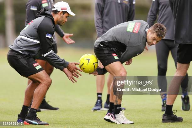 Jamie Elliott of the Magpies plays Tunnel Ball with Daniel Wells during a Collingwood Magpies AFL training session at the Holden Centre on April 01,...