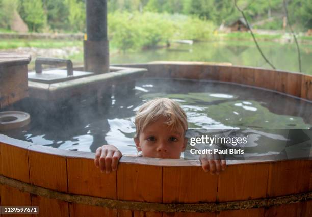 hot tub, taking a relax bath in the middle of nature - young boy in sauna stock pictures, royalty-free photos & images