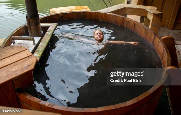 hot tub, taking a relax bath in the middle of nature - young boy in sauna stock pictures, royalty-free photos & images