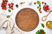 Wooden pizza board and pizza cooking ingredients