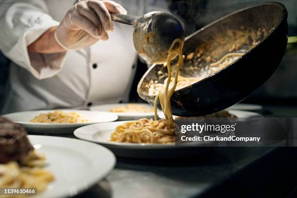 chef serving spaghetti - cook restaurant stock pictures, royalty-free photos & images