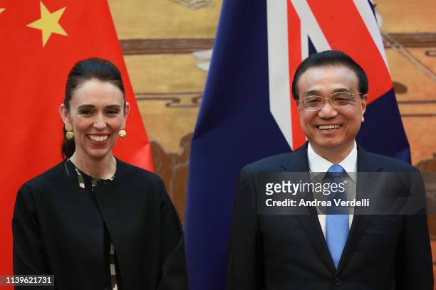 New Zealand Prime Minister Jacinda Ardern and Chinese Premier Li Keqiang smile during the signing ceremony at The Great Hall Of The People on April...