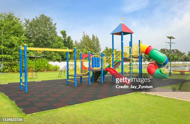 outdoor playing equipment on playground - playground stock pictures, royalty-free photos & images
