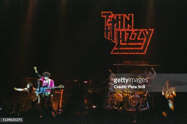 Gary Moore, Phil Lynott, Brian Downey and Scott Gorham of Thin Lizzy acknowledge the fans at the end of their performance on stage at Hammersmith...