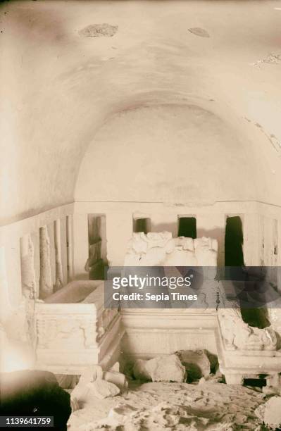 Palmyra. Tomb of the three brothers. Right hand chamber showing sarcophagi, loculi and portrait and group carvings. 1920, Syria, Tadmur