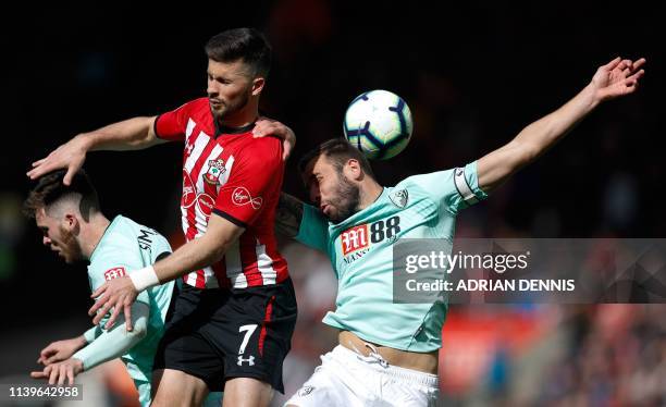 Southampton's Irish striker Shane Long jumps against Bournemouth's English defender Steve Cook for the ball during the English Premier League...