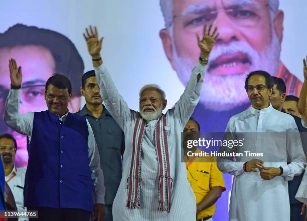 Prime Minister Narendra Modi with Maharashtra Chief Minister Devendra Fadnavis, and Shiv Sena chief Uddhav Thackeray during an election campaign...