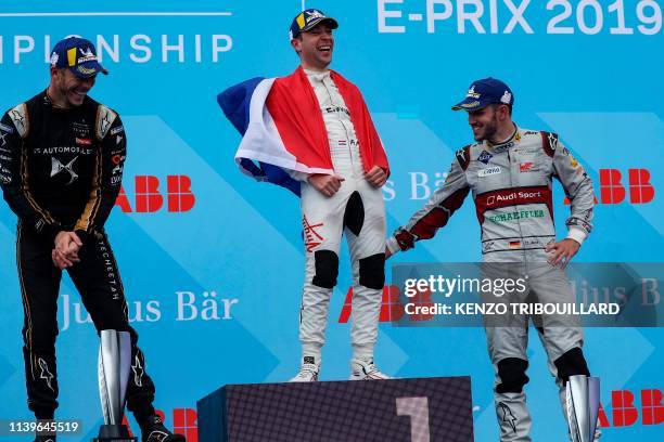 Virgin Racing's Dutch driver Robin Frijns celebrates his victory with second-placed Techeetah's German driver Andre Lotterer and third-placed Audi...