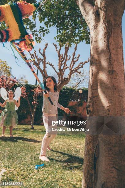 boys breaking piñata at a party - tiny mexican girl stock pictures, royalty-free photos & images